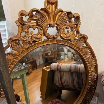 Ornate giltwood carved round beveled wall mirror