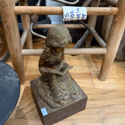 Brass girl reading figurine and primitive stool