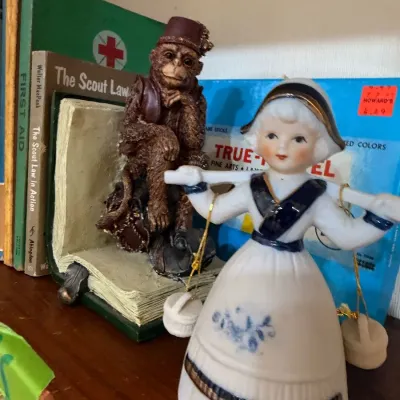 Porcelain Dutch girl bell and monkey bookend