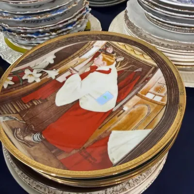 Stacks of collector plates and vintage china