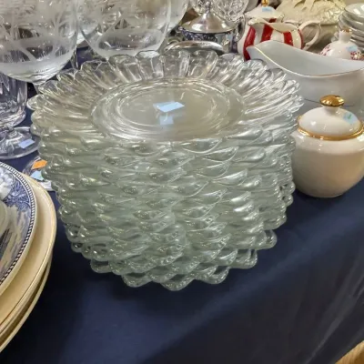 Stack of scalloped pressed glass luncheon plates