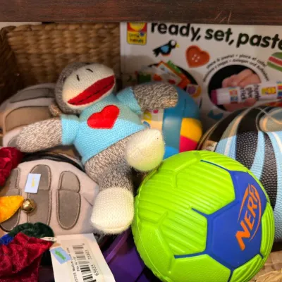 Basket of children's toys with sock monkey plush