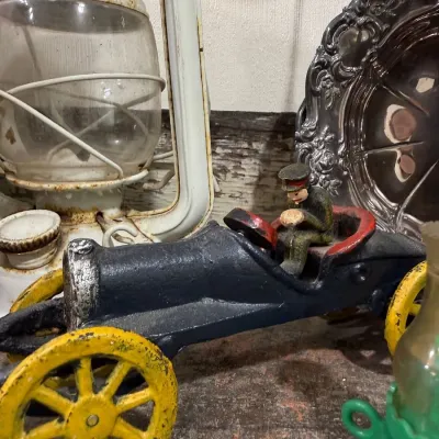 Antique cast iron toy race car with driver