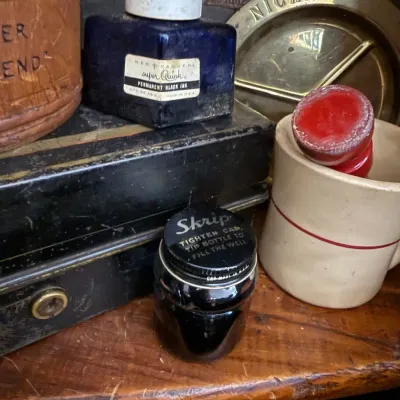 Vintage Skrip and Quink ink bottles with stoneware mug