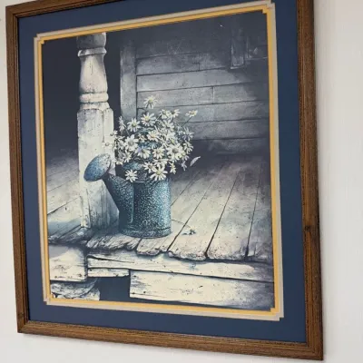 Framed daisies in watering can print, blue mat