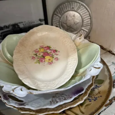 Stack of antique floral china plates