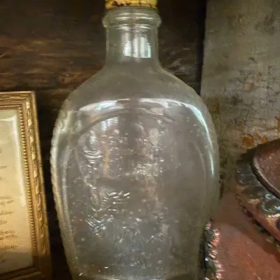 Antique embossed clear glass flask with cork