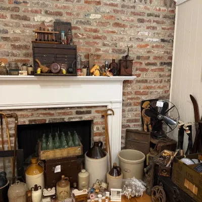 Brick fireplace with stoneware crocks and jugs