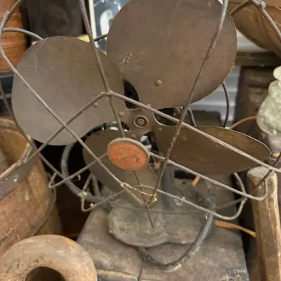 Antique electric fan with metal blades and cage