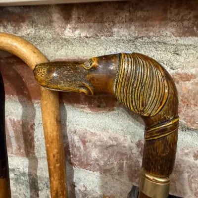 Carved dog head walking cane with brass collar