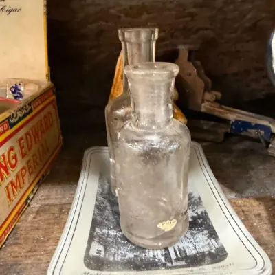 Two antique clear glass apothecary bottles