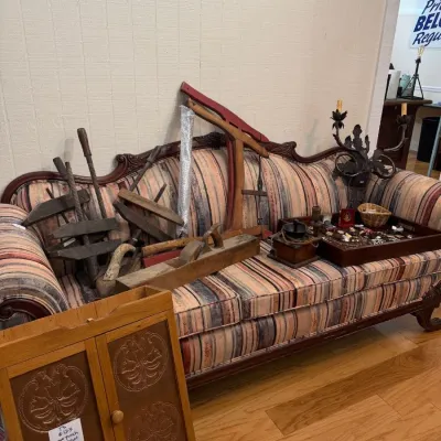 Victorian carved sofa with antique wood clamps and punched tin cabinet