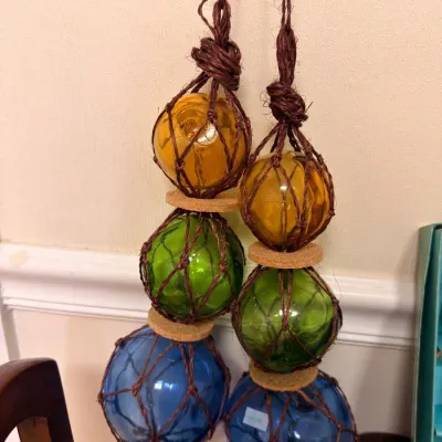 Colored glass fishing floats in rope netting