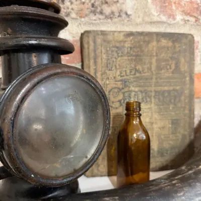 Antique carriage lamp with early geography book
