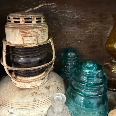 Antique nautical lantern with aqua glass insulators