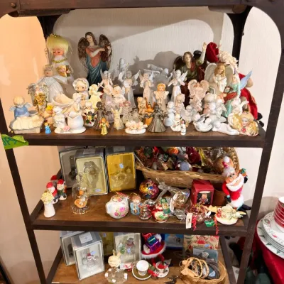 Etagere of angel figurines and Christmas collectibles
