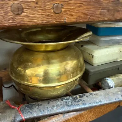 Antique brass spittoon with primitive hand tools