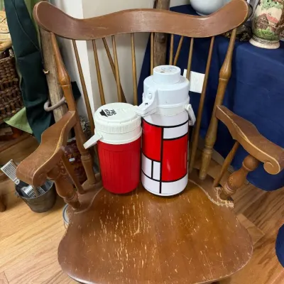 Maple captain's chair with vintage picnic thermos jugs