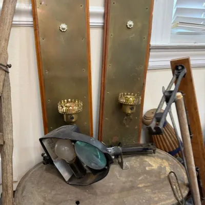 Pair of brass wall sconces on wood backplates