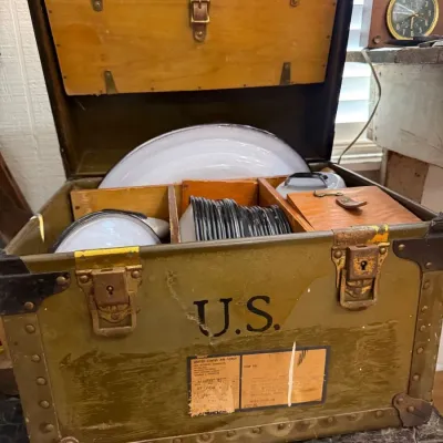 US Air Force footlocker with enamelware plates and mess kit