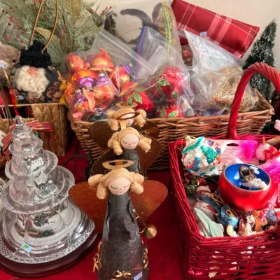 Baskets of Christmas ornaments with lighted glass tree