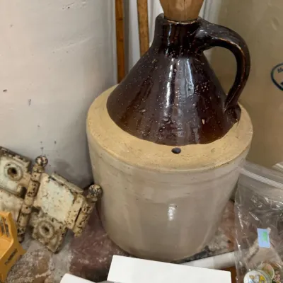 Antique stoneware whiskey jug with cork stopper