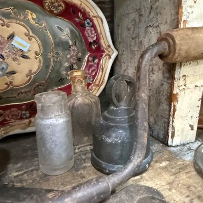 Antique wrench, hand tools and glass bottles