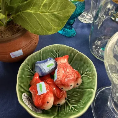 Ceramic goldfish figurines in green cabbage leaf bowl