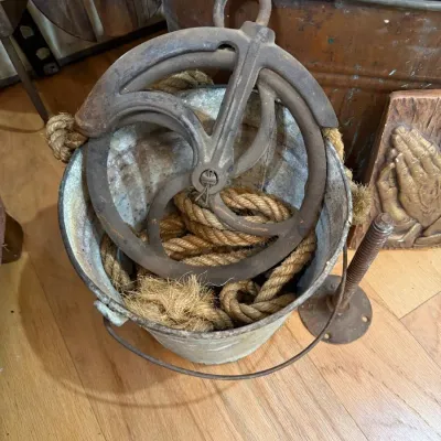 Cast iron barn pulley and rope in galvanized bucket