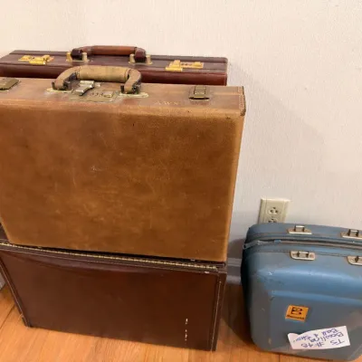 Vintage leather briefcases and blue hard-shell suitcase