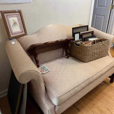 Camelback settee with cream upholstery