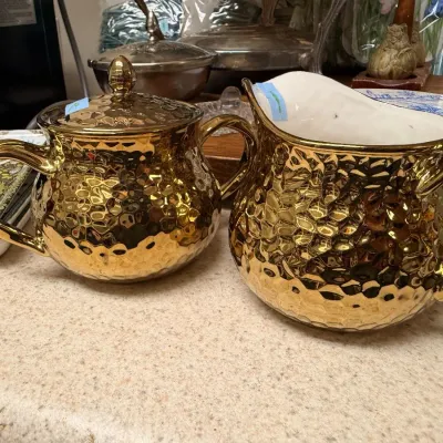 Gold ceramic sugar bowl and creamer set