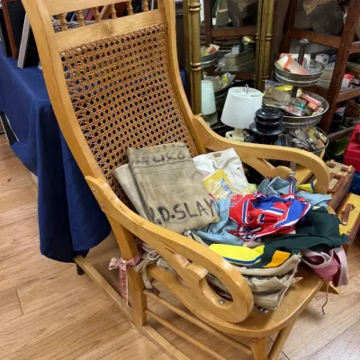 Antique cane back rocking chair with textiles
