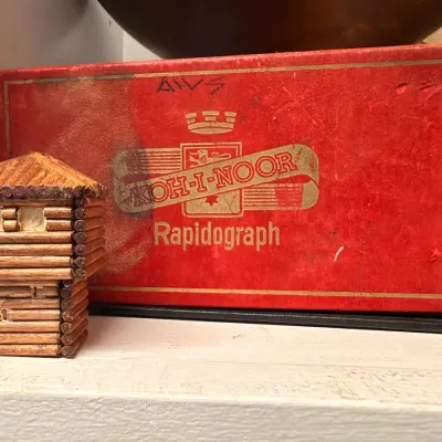 Koh-I-Noor Rapidograph box and log cabin bank