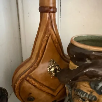Leather clad decanter with brass crest