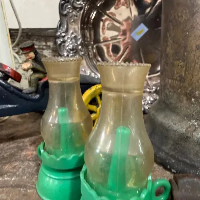 Pair of green kerosene finger lamps with chimneys