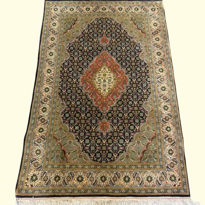 Sale Photo Thumbnail #137:     Intricate traditional rug with a detailed medallion and rich jewel-toned accents.