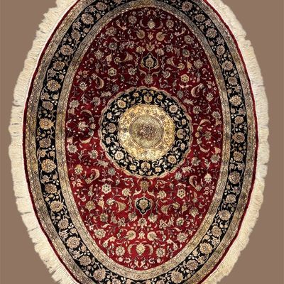 Sale Photo Thumbnail #77: Oval red rug with a dramatic circular medallion design.