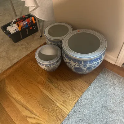 Sale Photo Thumbnail #105: Trio of blue and white ceramic fishbowl planters in graduated sizes, featuring traditional Chinoiserie floral designs and Greek key borders.