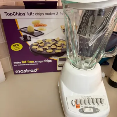 Sale Photo Thumbnail #68: Hamilton Beach 14-speed blender with a white base and glass jar, shown alongside a boxed Mastrad TopChips microwave chip maker kit.