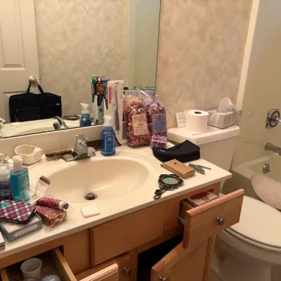 Sale Photo Thumbnail #27: Assortment of bathroom toiletries and personal care items, including a boxed Windmere hair styler, bags of potpourri, hand soaps, and small accessories.
