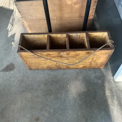 Sale Photo Thumbnail #110: Vintage rustic wooden tote with four divided compartments and a rope handle, shown alongside a larger wooden crate filled with pinecones.