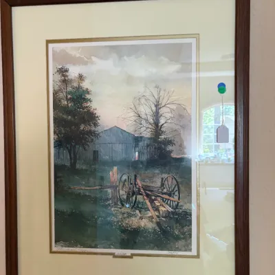 Sale Photo Thumbnail #94: Framed limited edition print titled 'Last Light' by Michael Sloan, numbered 1349/1500, depicting a rustic barn and wagon scene. The print is double-matted and housed in a dark wood frame.