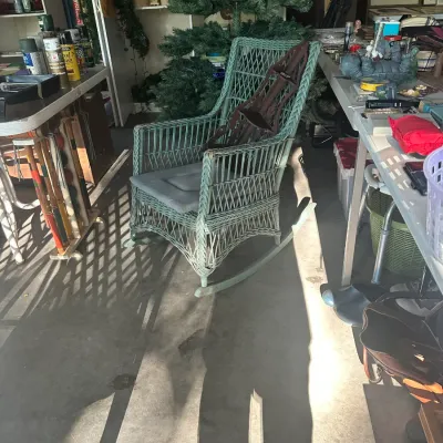 Sale Photo Thumbnail #112: Vintage green-painted wicker rocking chair with a high back, woven lattice details, and a grey seat cushion.