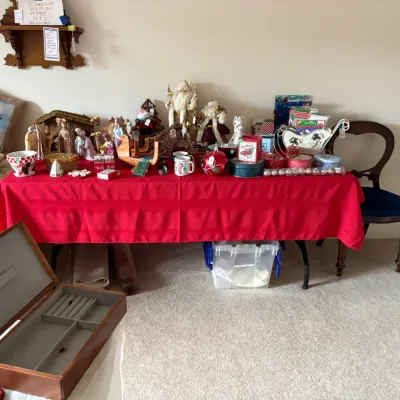 Sale Photo Thumbnail #13: Assortment of vintage Christmas decorations, including Santa figurines, a nativity scene, and holiday tins, alongside an open wooden jewelry box.