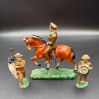 WWI Military Figurines Featuring A Solider On Horseback, A Military Band Member And A Flagbearer 