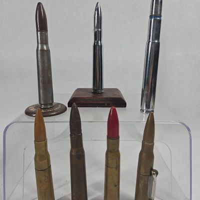 Sale Photo Thumbnail #248: Set 7 .50 BMG Trench Art & Advertising