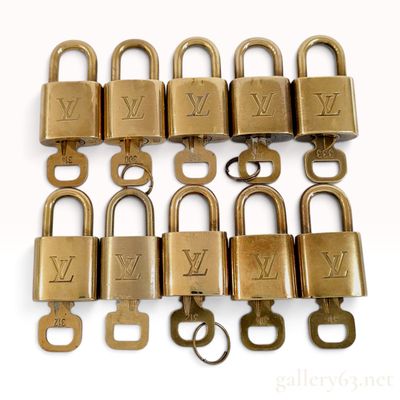 Sale Photo Thumbnail #239: A Collection of Ten Louis Vuitton Brass Toned Handbag Padlocks and Keys