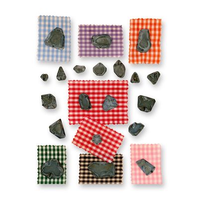 A CARD OF REALISTIC SHAPED METAL BUTTONS