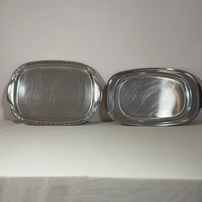 PAIR OF STAINLESS STEEL SERVING TRAYS INCLUDING MID-CENTURY MODERN STYLE
This pair includes two rectangular stainless steel serving trays...